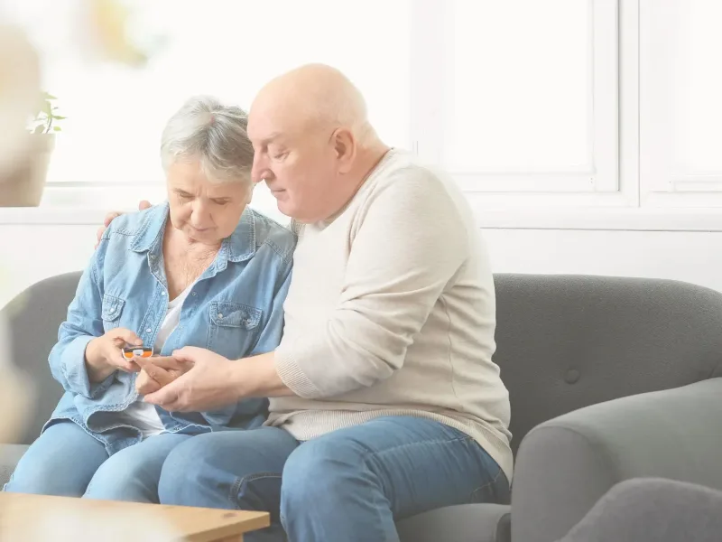Older couple doing a blood sugar test