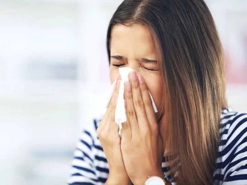 Woman sneezing