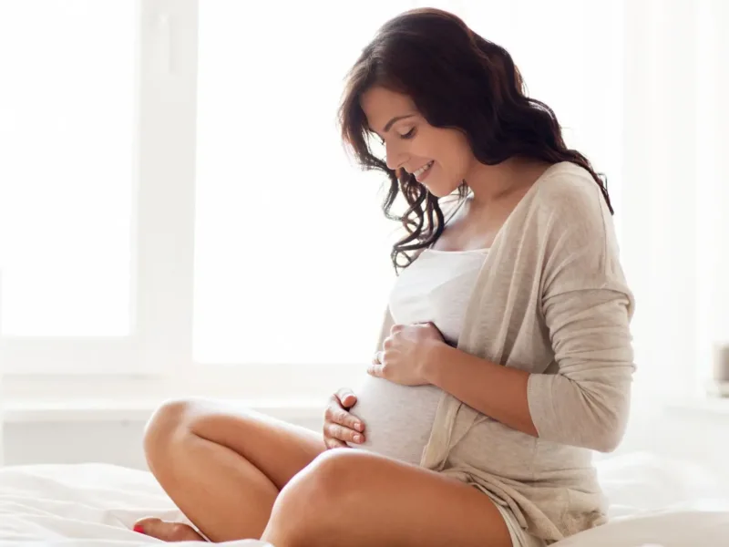 Pregnant woman on bed