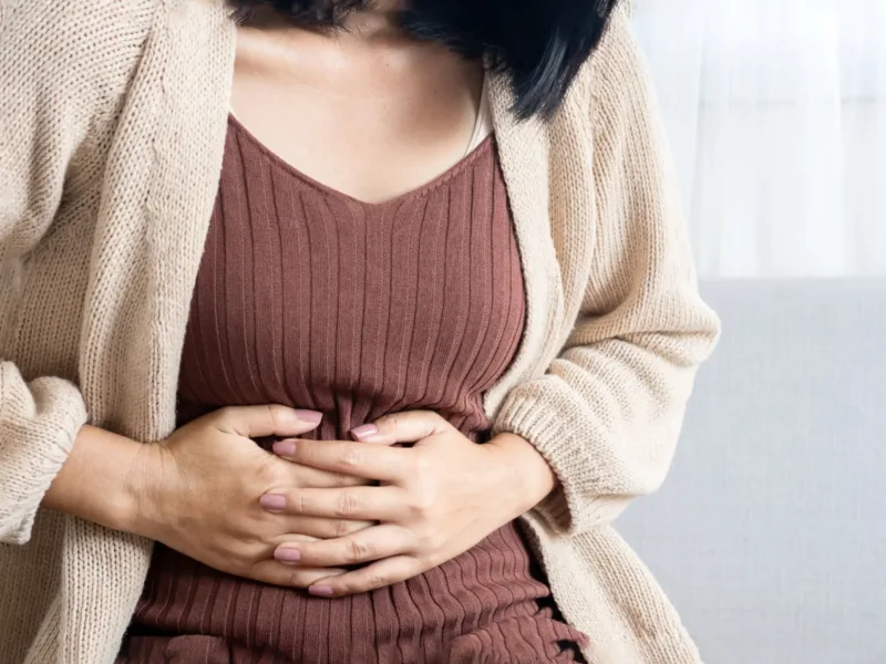 Woman holding her abdomen