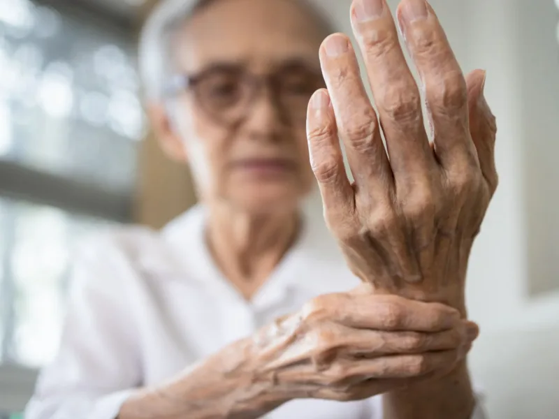 Person holding their wrist