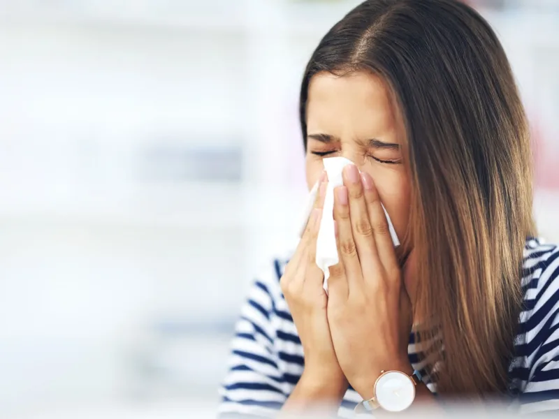 Woman sneezing