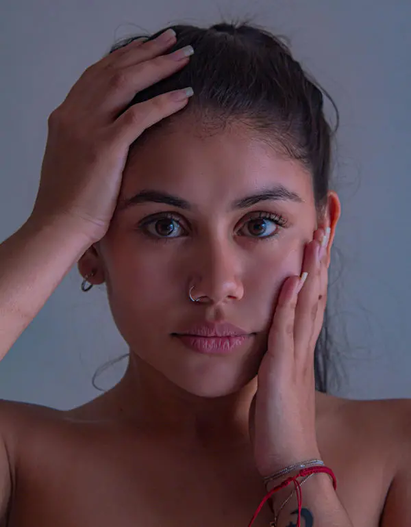 Woman holding her face