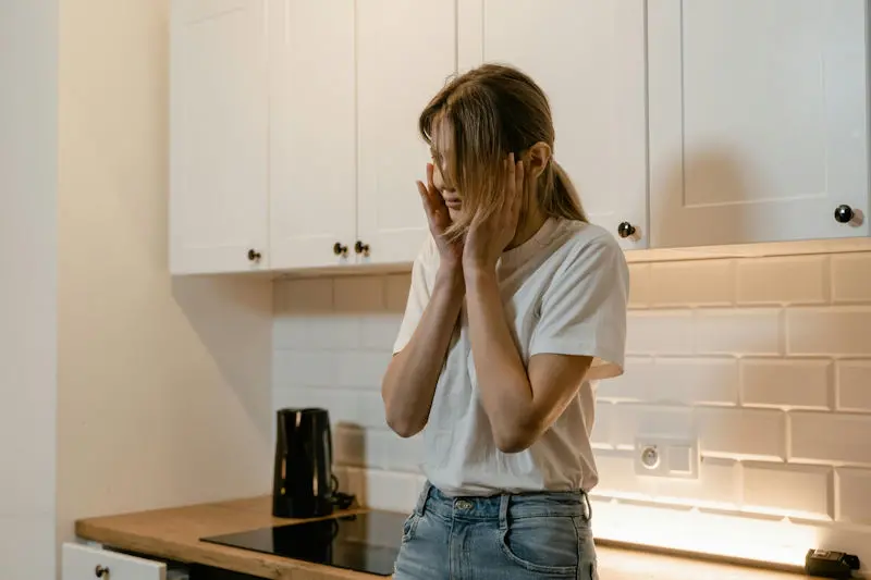 Woman holding her face